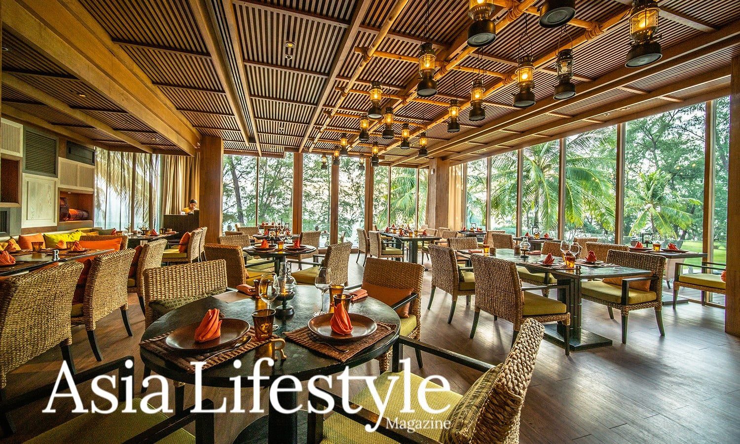 Takieng Restaurant Teams Up With Blue Elephant To Promote Phukets Heritage Recipe The dining room of a Thai restaurant with lantern lighting and windows onto garden greenery