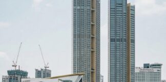 Bangkok Among the World’s Priciest Cities for Wealthy Travelers Passengers on a Chao Phraya river ferry pass Iconsiam and high-rise towers in Bangkok