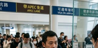 China Advocates Travel Ease at APEC Tourism Talks in Macau A traveller hands a passport and health declaration to an officer at an Asian airport immigration desk