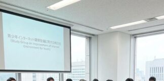 Japan’s Bold Move: Social Media Ban for Kids on the Horizon? Japanese officials sit around a conference table beneath a slide titled Study Group on Improvement of Internet Environment for Youth