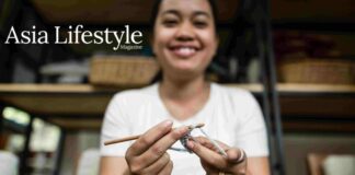 Embracing hygge in the Kingdom of Wonder A smiling woman crochets with a wooden hook, shelves of woven baskets behind her