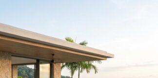Phuket Offers GCC Expats More Than Just a Climate Tax: Discover Exciting Opportunities and Benefits A couple sit at an outdoor dining table beside a villa pool overlooking a Phuket bay at dusk