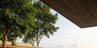 Phuket: Discover the Quiet Luxury Welcomed by Wealthy Dubai Travelers A woman reads on a lounger beside a hillside infinity pool overlooking a Phuket bay
