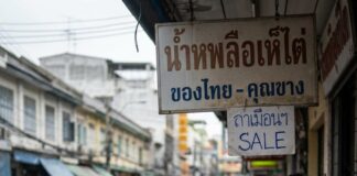 Will Songkran Spending Take a Dive This Year? Shoppers browse stacked water pistols and buckets at a Bangkok pavement stall before Songkran