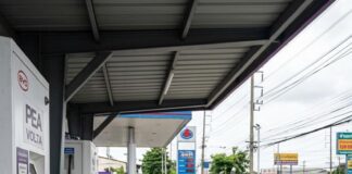 Thailand’s EV Plan to Replace 80,000 Vehicles A driver plugs a charging cable into an electric car at a Thai PEA Volta charging station