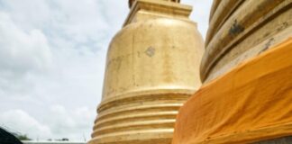 Wat Phra Mahathat Goes World Heritage: Why It Matters Worshippers pass a long saffron cloth hand to hand around the base of a golden chedi