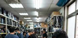 Customers examine processor chips laid out in a glass display case at an electronics components shop