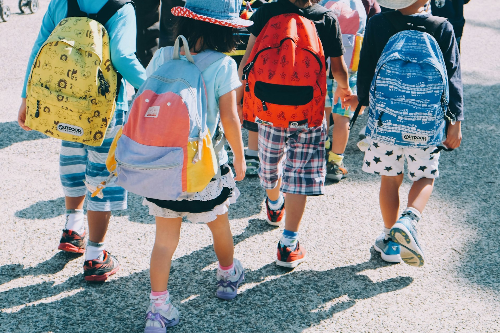 Young children with backpacks walking to school
