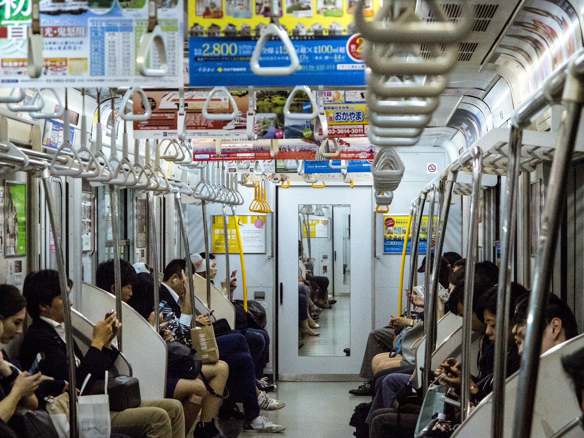 Passengers sitting quietly on a subway train in Japan