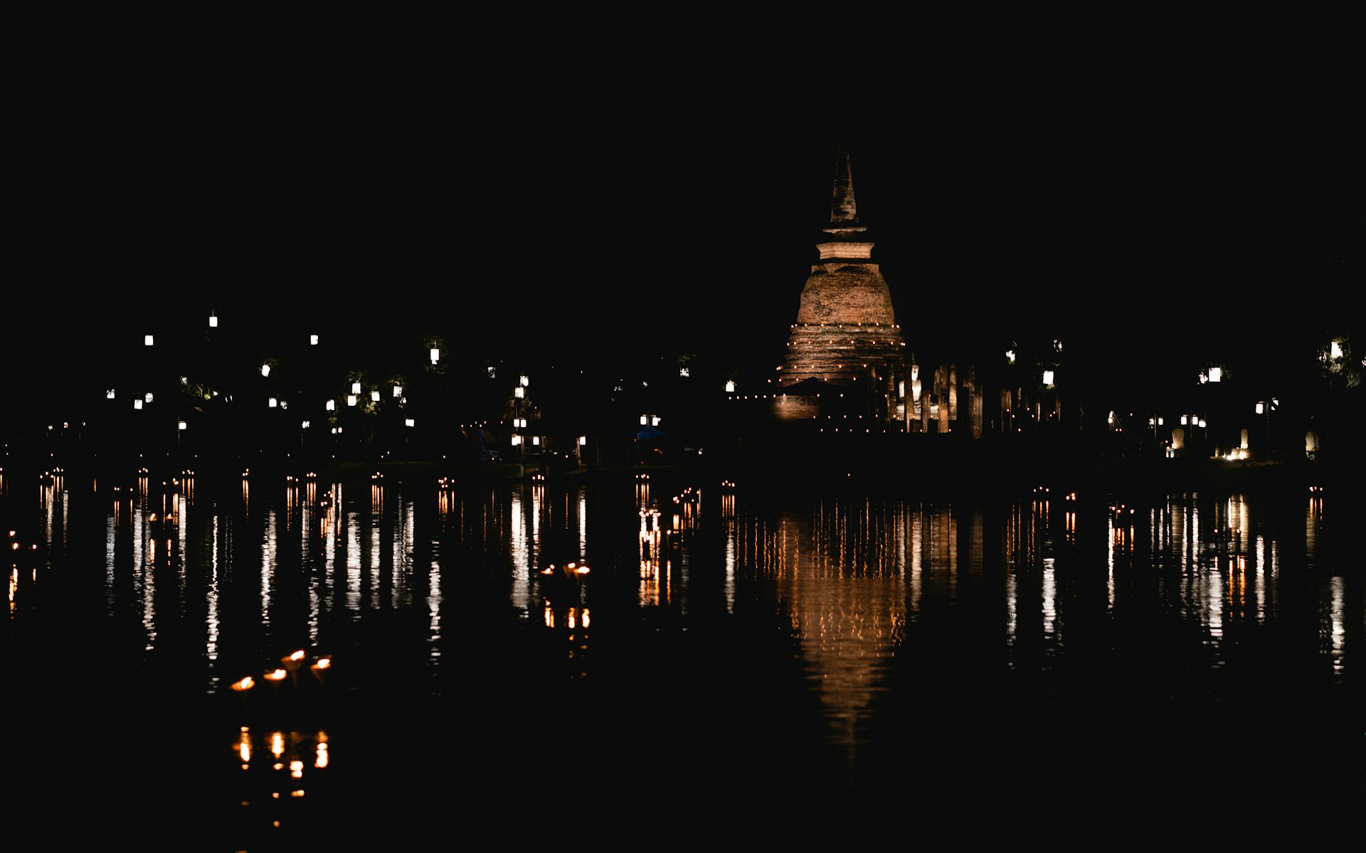 Candles on the water at Sukhothai Historical Park during Loy Krathong, Thailand