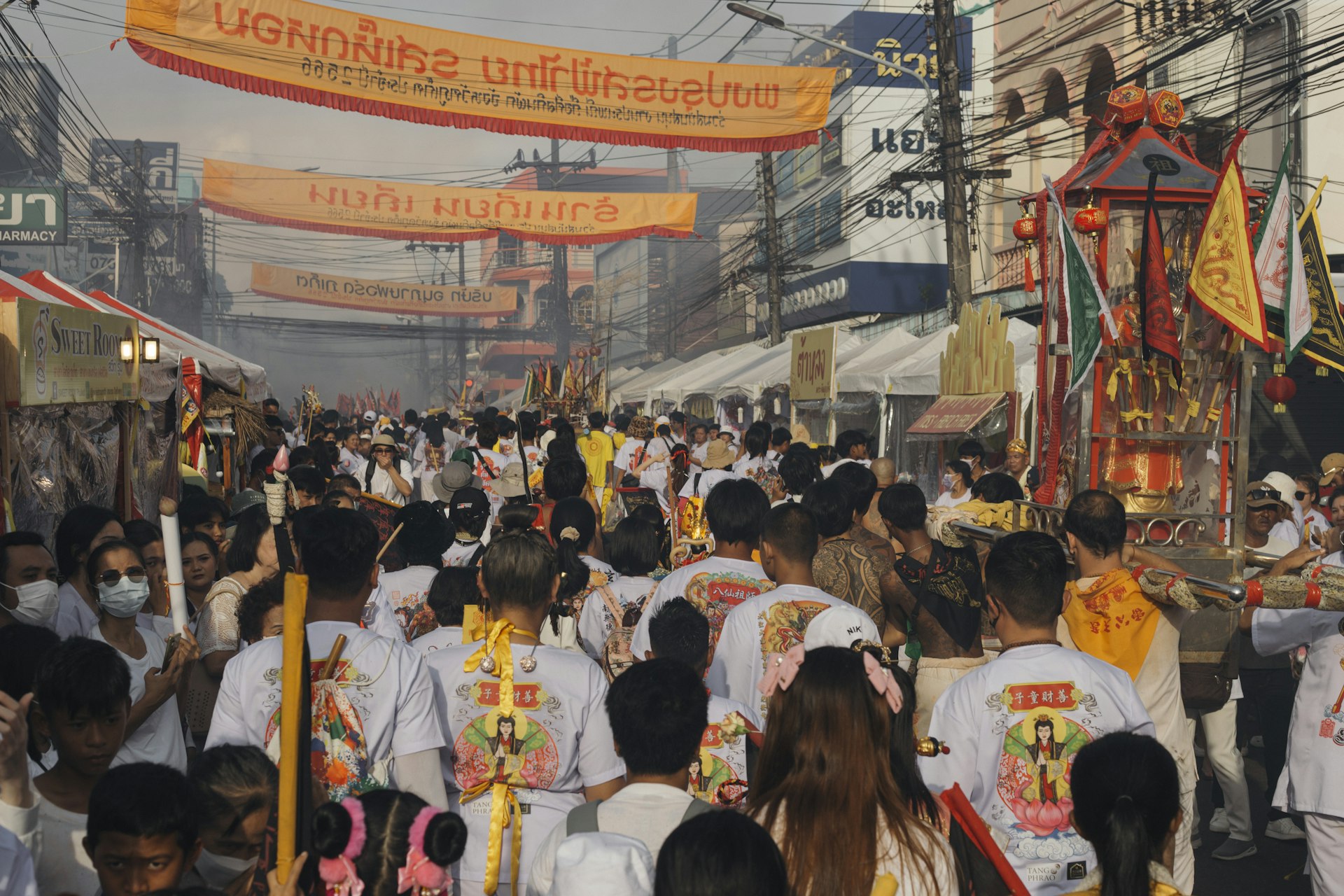 Crowds following a street procession during the Phuket Vegetarian Festival