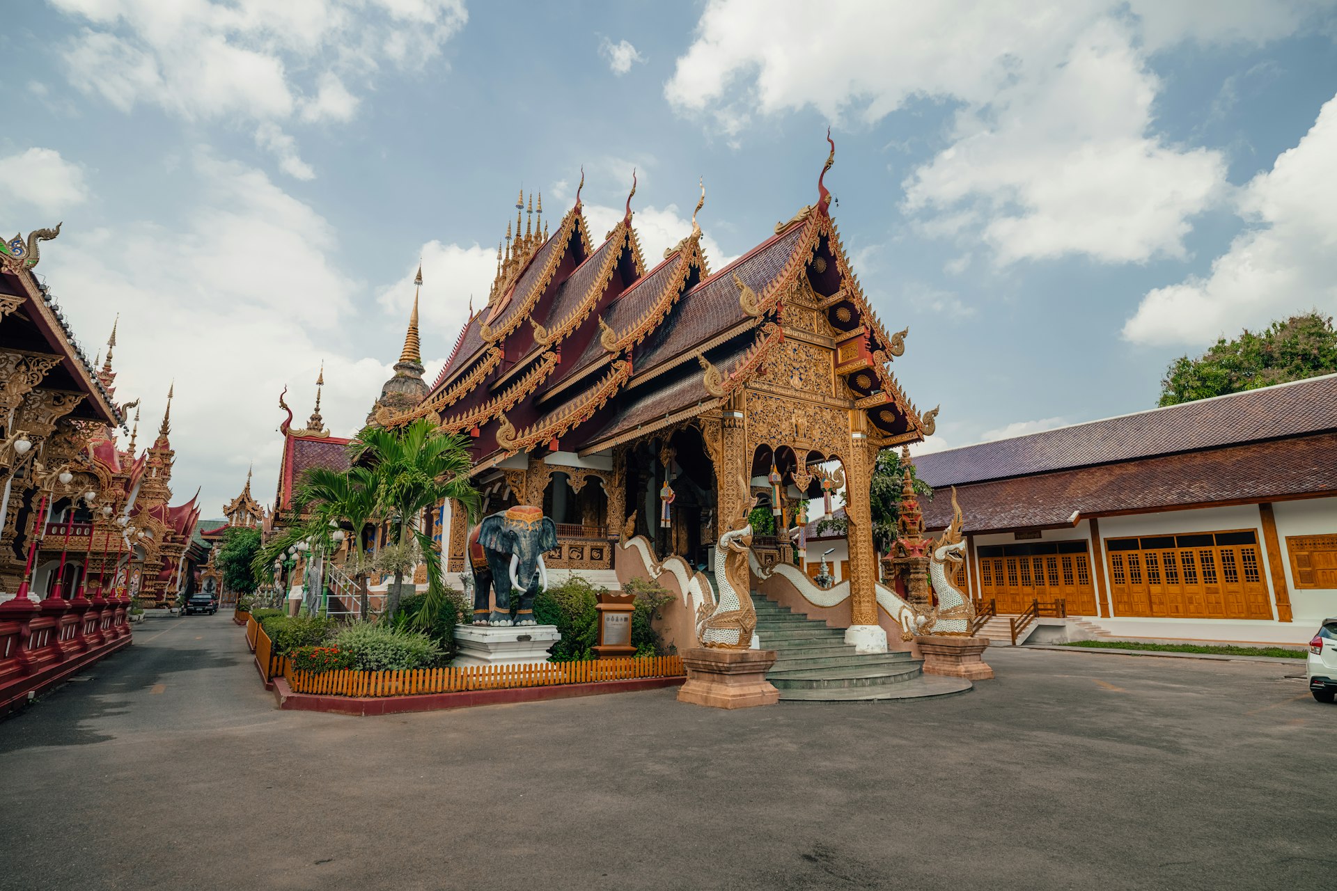 Buddhist temple buildings of a wat in Thailand under a cloudy sky