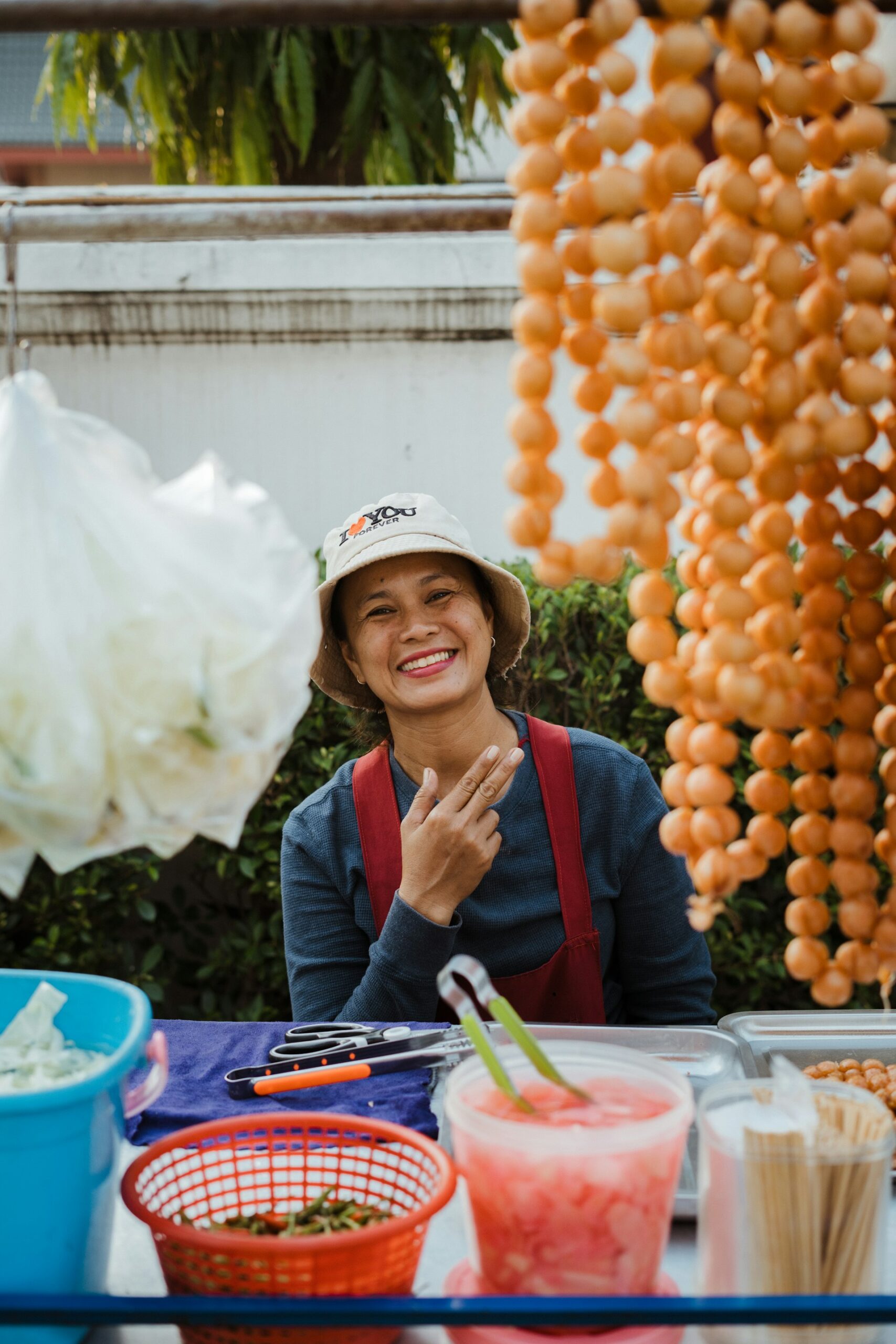 Smiling street food vendor at her stall in Bangkok, Thailand